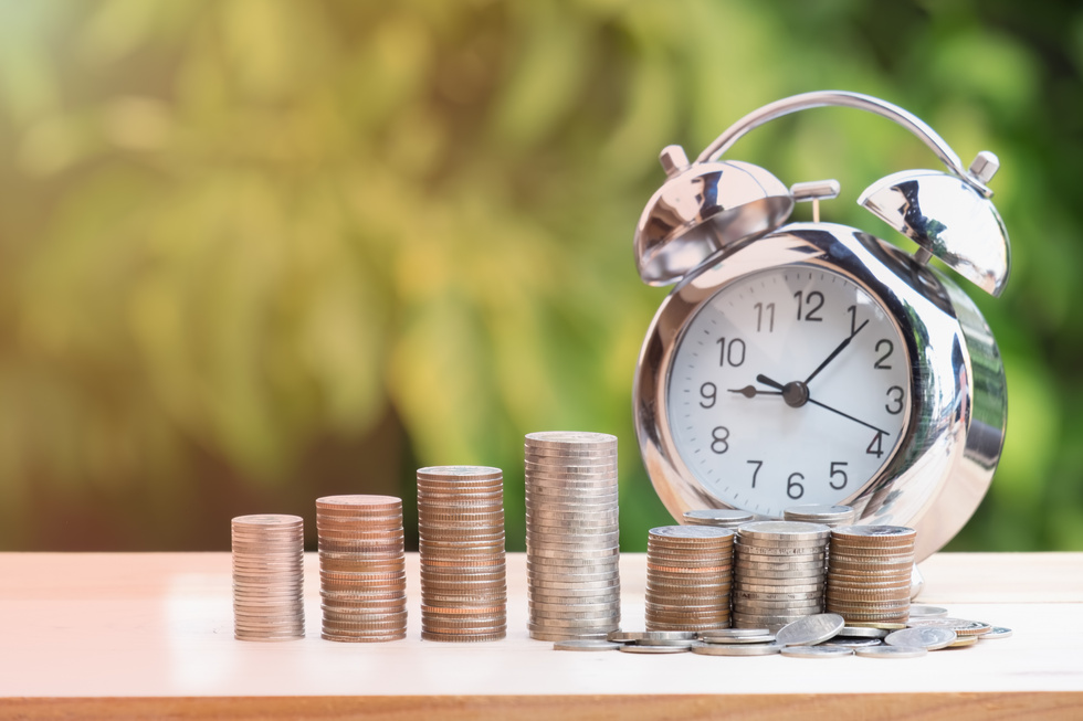 Close up of Time and Money with Green Bokeh Background ,Business